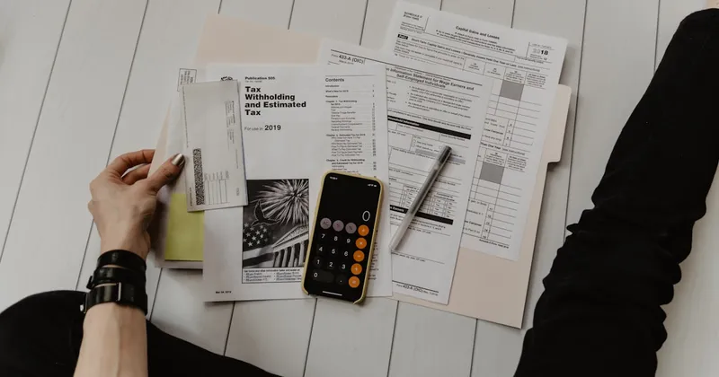 Calculator and invoice papers used to estimate support phone costs